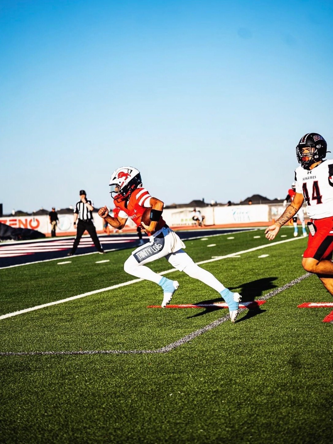 Trinity Lions quarterback running with the ball, DigiWrist on the wrist
